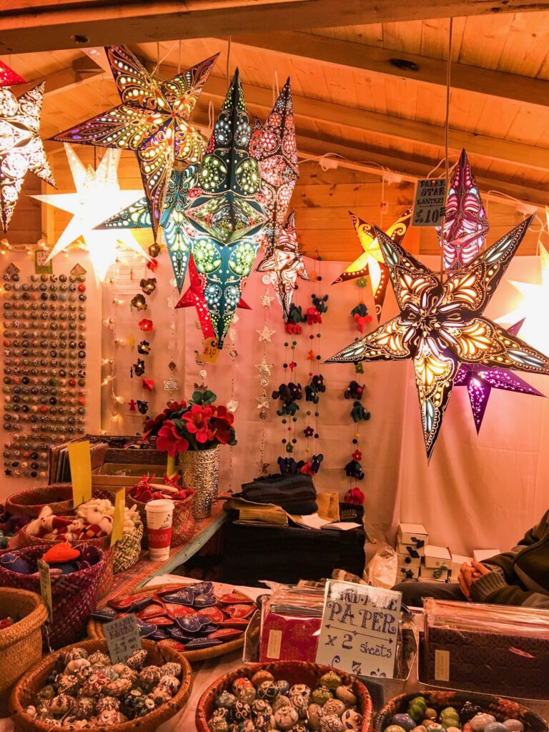 Star shaped glass lightshades at street market in Bath